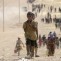 Children from minority Yazidi sect, fleeing violence from forces loyal to Islamic State in Sinjar town, make way towards Syrian border, on outskirts of Sinjar mountain